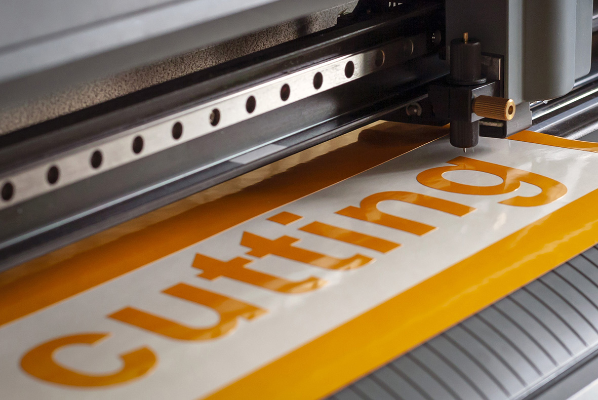 Cutting plotter close-up. The process of cutting a vinyl film.